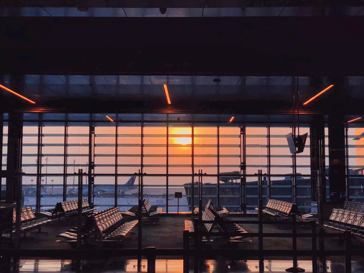 Airport departure gate with seating at sunset