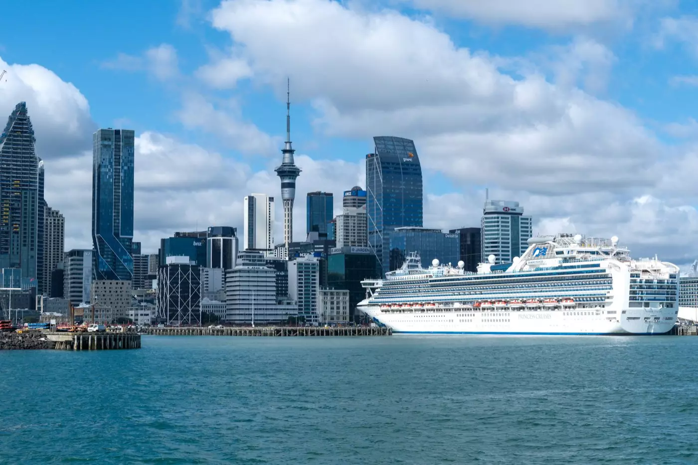 Cruise ship berthed in front of the Auckland city skyline